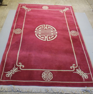 A pink ground Chinese rug with central ivory medallion and matching border 109 1/2" x 71"  
