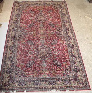 A red and blue ground Persian rug with central medallion 