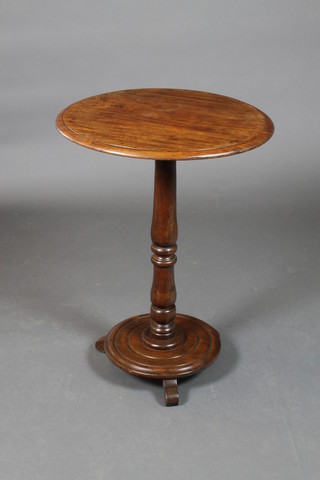 A Victorian circular mahogany wine table, raised on a turned column with circular base and scroll feet 28 1/2"h x 20 1/2" diam. 