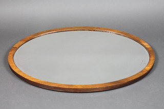 An oval bevelled plate wall mirror contained in an oak frame 35"h x 25 1/2"w