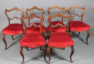 A set of 6 Victorian rosewood buckle back chairs with shaped mid rails, the seats on serpentine outline, raised on French cabriole supports 