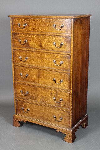 A Georgian style oak chest of 6 long drawers with brass swan neck drop handles, raised on bracket feet 54"h x 31 1/2"w x 18"d 