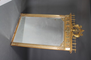 A Victorian arch shaped bevelled plate wall mirror contained in a decorative gilt frame surmounted by an urn of fruit 76"h x 50"w