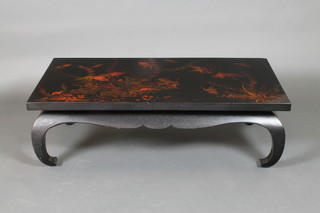 A rectangular black lacquered Viatnamese opium table, raised on shaped legs decorated carp, 15"h x 48"w x 24"d 