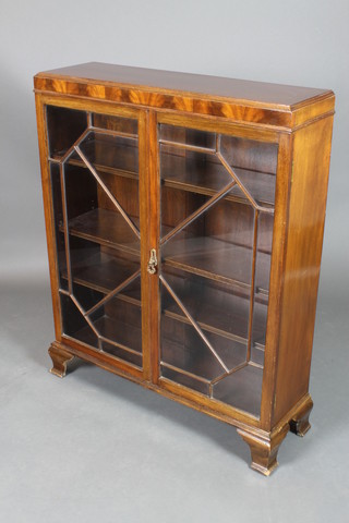 A Georgian style mahogany display cabinet, the shelved interior enclosed by astragal glazed panelled doors and raised on ogee bracket feet 43 1/2"h x 35"w x 10 1/2"d 