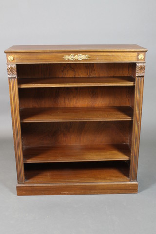 An Empire style mahogany bookcase, the interior fitted adjustable shelves and having carved columns to the side with vitruvian scrolls, 42"h x 36"w x 13 1/2"d