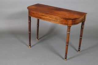 A Georgian mahogany demi-lune table with ebonised stringing, raised on turned supports 27 1/2"h x 36"w x 17"d 