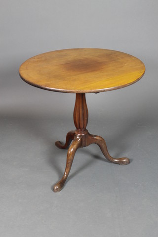 A Victorian circular mahogany snap top tea table raised on turned and reeded column with tripod base, 28 1/2"h x 30" diam.