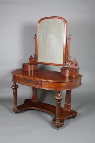 A Victorian mahogany Duchess dressing table with arched plate mirror to the back, the base fitted 2 glove drawers above 1 long drawer raised on turned and fluted supports 64 1/2"h x 46 1/2"w x 22 1/2"d 
