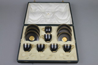 A boxed set of 6 Royal Worcester black and gilt coffee cups and saucers with Greek pattern borders