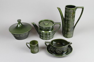 A Portmeirion green glazed Totem coffee, tea and dinner service comprising 6 coffee cans, 6 saucers, 6 tea cups, 6 saucers, teapot, coffee pot, milk jug, cream jug, 2 sugar bowls, 2 tureens and covers, a sauce boat and stand, an oval meat plate, 7 dinner plates, 6 side plates, 11 sandwich plates