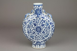 A Chinese 19th Century blue and white moon vase with dragon handles and geometric floral motifs 11" (one handle is stuck and chipped and the other chipped there is also a chip to the lip)