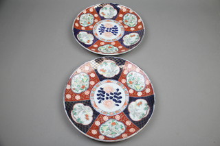 A pair of Japanese Imari shallow dishes decorated with panels of flowers, birds and bamboo 13" 