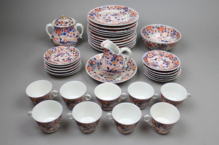 An Imari tea set comprising 9 tea cups, 12 saucers, a milk jug, sugar bowl, bowl, 12 dinner plates and a dish 