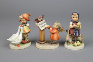3 Hummel figures, a girl with geese 473/0 4", an Angel before a lectern 169 4" and a girl with chickens and chicks 199/0 4" 