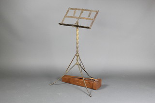 An Edwardian pierced brass adjustable music stand raised on a spiral column and marked "Presented to Mr W S Robinson BA by the Musical Union Malta, complete with leather carrying case 