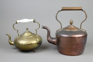 A Victorian brass kettle with ceramic handle and a copper kettle