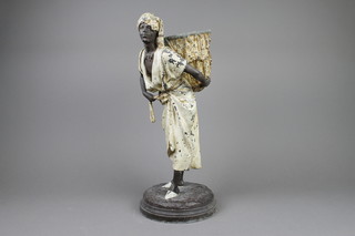 After L Hottot, a bronze and spelter figure of a standing nubian tea picker with panier, (panier lid possibly missing) raised on a circular base 17" 