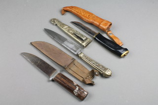 A Continental dagger with 5 1/2" blade contained in an embossed metal sheath, the knife with 4 1/2" blade and wooden grip together with a dagger with 4" blade
