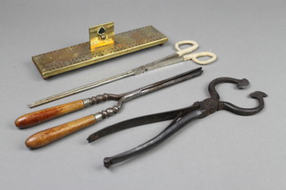 A rectangular pierced brass cribbage board 6", a pair of sugar cutters, a pair of curling tongs and a pair of ember tongs 