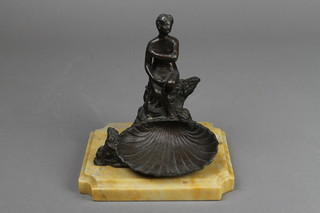 A bronze scallop shaped dish with a figure of a kneeling naked lady raised on a shaped marble base 6" 