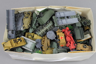 A collection of various plastic military model vehicles