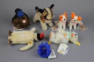 A Steiff figure of a dog 6", a Steiff figure of a peacock 6 1/2", a Steiff figure of a penguin 7", a Steiff blue Centenary bear 1904-2004 4", a Steiff bear Zotty 1960 6", 2 Steiff figures of seated dogs 4" - Bully