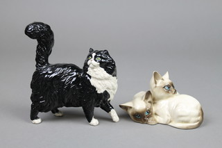 A Royal Doulton group of 2 Siamese cats 1296 4 1/2" and a ditto of a black and white cat 5" 