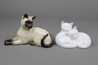 A Royal Doulton figure of a reclining Siamese cat 1558 7", a ditto Sleepy Heads HN3894 4" 