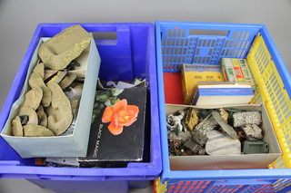A shallow plastic folding crate containing various plastic models and a blue crate containing models etc