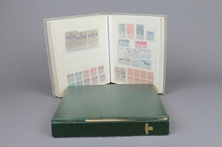 A green stock book of various World stamps, a grey stock book of various stamps