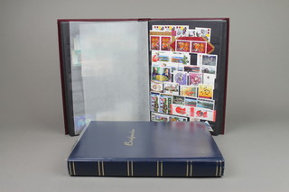 A red stock book of Canadian mint stamps together with a blue stock book of various Canadian stamps