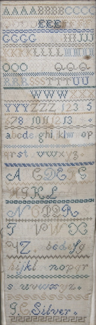 P C Silver, a 19th Century woolwork sampler with alphabet and numbers, some staining 25" x 7 1/2" 