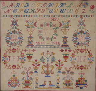 A 1950's woolwork sampler commemorating 4 anniversaries with monograms and garden, contained in a Hogarth frame 11 1/2" x 12" 