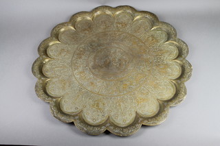 An engraved benares brass charger with lobed decoration 27" 