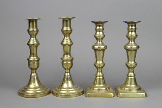 A pair of 18th/19th Century brass candlesticks with square bases and ejectors 8 1/2" together with a ditto pair with circular bases 9" 
