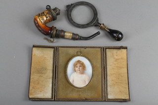 A portrait miniature of a child 13" oval contained in a fitted leather case, a carved pipe decorated a horse dated 1814 and a wooden handled magnifying glass