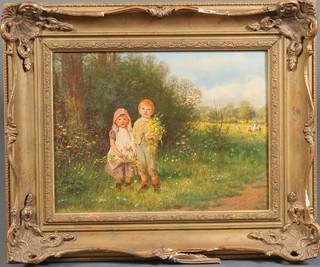 F O Banks, oil painting on board, a 19th Century study of 2 young children holding spring flowers in a field with distant farm workers, signed, ex Christies stock number on verso, 10" x 13" 