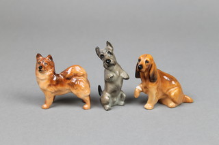 3 Royal Doulton figures of dogs, a seated spaniel K99 2 1/2", a standing terrier K15 2 1/2" and a crouching terrier K10 2 1/2"  