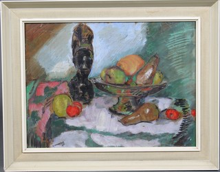 G Cassapides, oil painting.  A still life study of a bowl of fruit and a carved bust, signed and dated 1955 15 1/2" x 21" 