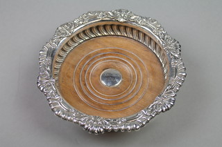 A George III silver wine coaster with fluted and scroll rim with demi-fluted body 5" 