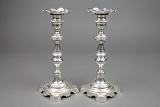 A pair of Continental silver turned and tapered candlesticks with bright cut decoration and lappet sconces, approx. 1036 grams 9" 