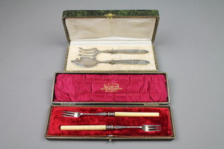 A pair of cased Edwardian silver and ivory pickle forks with spiral stems, Sheffield 1902, a cased pair of Continental servers