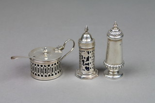 A Victorian tapered silver pepperette, London 1899, a pierced silver ditto with blue glass liner and a pierced mustard, approx. 112 grams