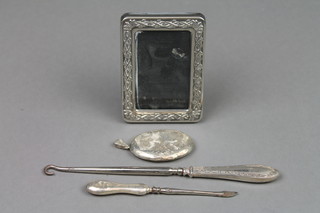 A silver handled button hook and 3 other items