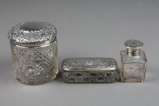 An Edwardian repousse silver mounted toilet jar Birmingham 1907, a ditto bottle and rectangular box with Reynolds angel lid