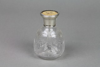 A cut glass toilet bottle with silver lid 4"