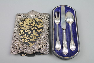 An Edwardian cased silver 3 piece christening set London 1900, a ditto repousse photograph frame