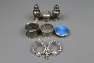 A pair of repousse silver pepperettes, 2 napkin rings and 3 other items