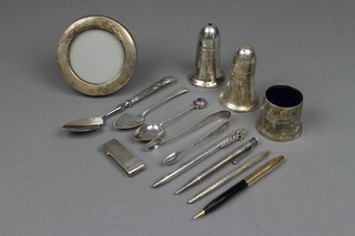 A circular silver photograph frame 3 1/2", a repousse ditto, a money clip and preserve spoon, minor plated items